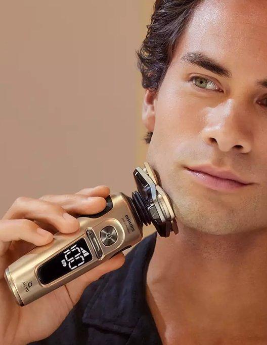 a man shaving his face with an electronic razor